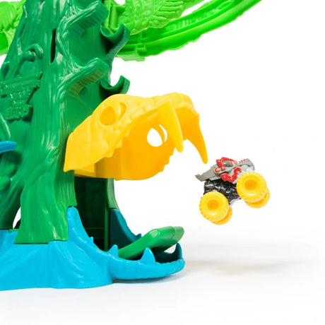 Mini monster truck shown beside the yellow cobra mouth on the Monster Jam Mini Jams playset
