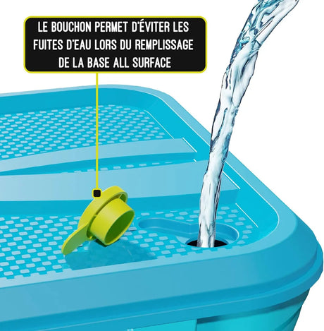 Turquoise Swingball base with yellow fill plug and water pouring into the opening
