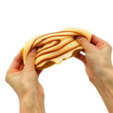 Mushmeez Taba Squishy cinnamon roll design stretched between two hands showing the layered filling