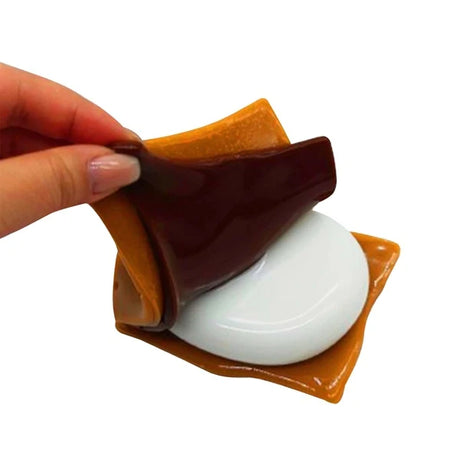 Mushmeez Taba Squishy s'more design with the brown and white layers being pulled apart by hand