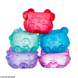 Five assorted MushyKinz Jelleez animal squishies stacked together in purple, pink, blue, green and red
