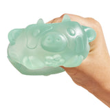Mint green MushyKinz Jelleez dog squishy being squeezed in a hand