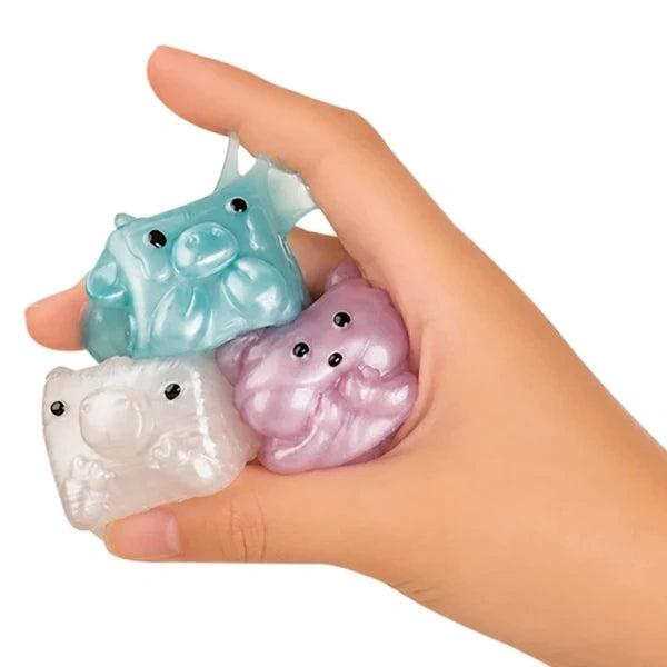 MushyKinz Shimmer Gemz blue, white and lilac pearl finish mini Taba squishies held in one hand