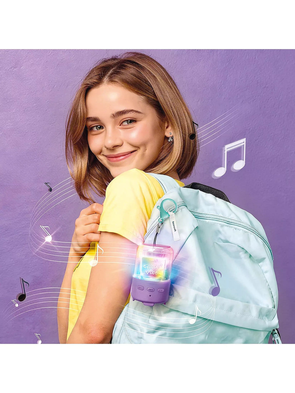 Pink Music Creator Mini Speaker attached to a light blue backpack with turquoise clip 