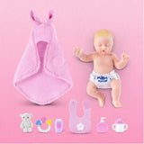 My Mini Baby newborn beside pink swaddle, teddy, bottle, bib, teether and feeding accessories