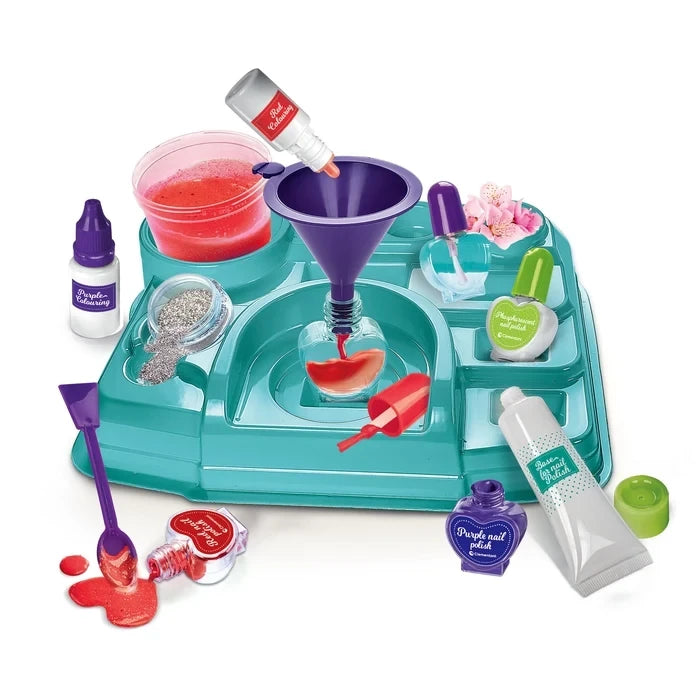 Nail Lab workstation with bowls, funnel, glitter, nail polish bottles, tools and a red nail tip.