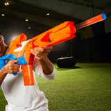 Person holding NERF N Series Pinpoint blaster with orange dart visible in front of the barrel