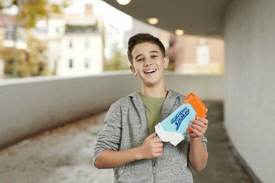 Child holding a NERF Super Soaker Torrent water blaster