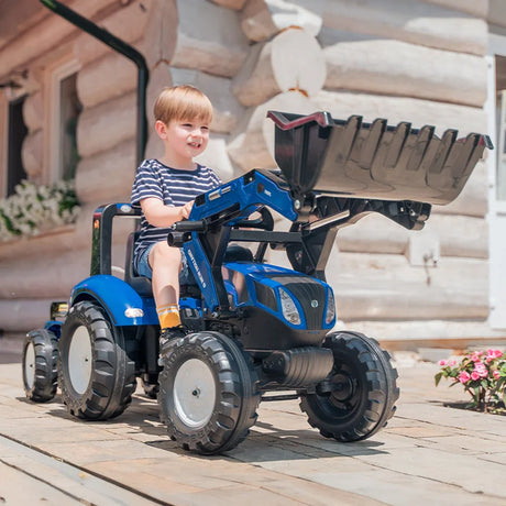 Child riding New Holland Blue backhoe with loader on paved path – Ireland