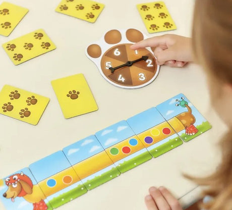 Child playing Orchard Toys Spotty Sausage Dogs spinning the paw spinner Ireland