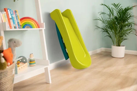 Green and blue folding slide shown folded in a room