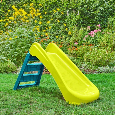 Green and blue folding slide opened on grass in a garden