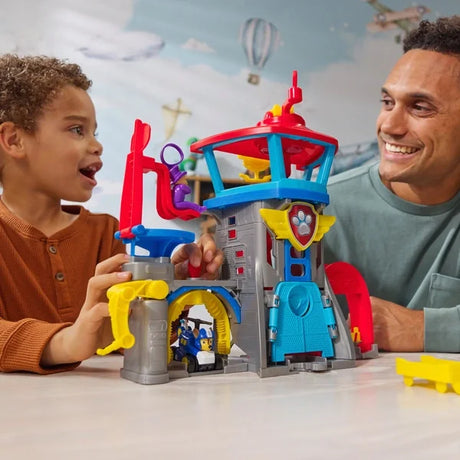 Child playing with Paw Patrol Air Rescue Pup Squad Airport playset on table in Ireland