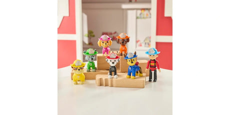 PAW Patrol Fire Rescue figures arranged on wooden blocks with Ryder and six pup figures