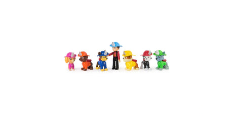 Ryder and six PAW Patrol pup figures shown in a straight lineup wearing fire rescue helmets