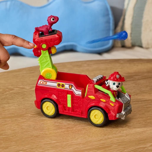 Hand pressing the launcher on the PAW Patrol Marshall Dino Rescue Fire Truck as a blue projectile fires