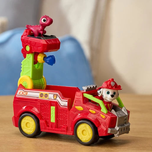 PAW Patrol Marshall Dino Rescue Fire Truck on a table with Marshall in the cab and red dinosaur figure on the raised ladder