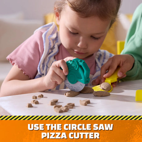Child using the circle saw pizza cutter from the Paw Patrol Rubble & Crew Growlin’ Grub Food Truck Playset