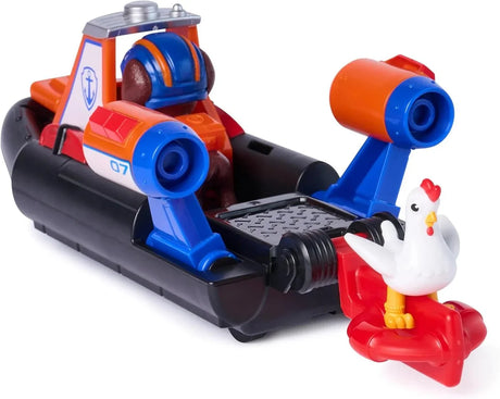 Close-up rear angle of PAW Patrol Zuma Rescue Hovercraft showing blue and orange launcher arm, black hull, and white chicken figure alongside