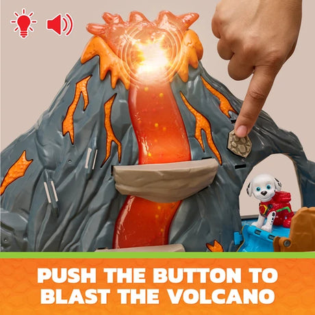 Hand pressing the button on the PAW Patrol Super Lava Blast volcano playset with the top glowing