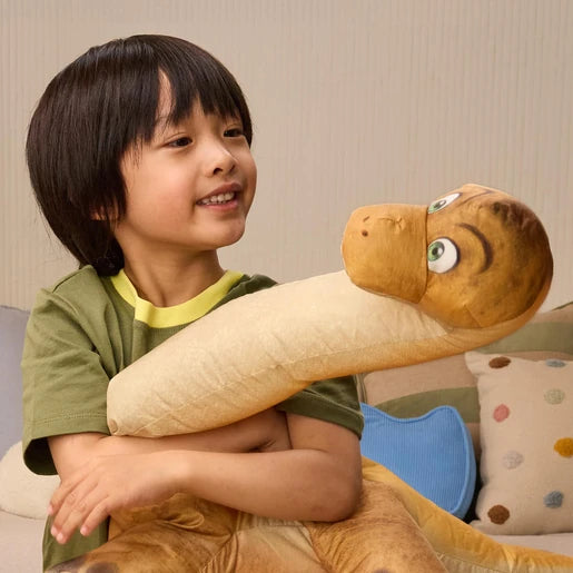 Child hugging the inflated long neck dinosaur from the Megasaurus Dino Vehicle set