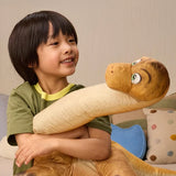 Child hugging the inflated long neck dinosaur from the Megasaurus Dino Vehicle set