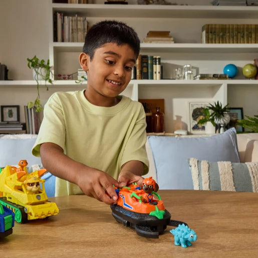 Child playing with the Zuma Dino Rescue Hovercraft, Zuma figure and blue dinosaur figure