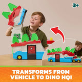 Child lifting the upper section of the PAW Patrol Dino Mobile Headquarters while another child plays with the vehicles