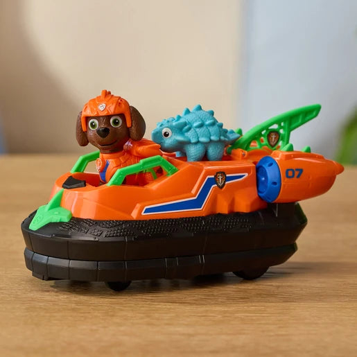 Orange Zuma Dino Rescue Hovercraft on a wooden surface with Zuma and the blue dinosaur figure