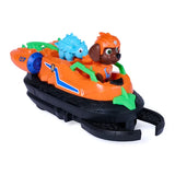 Zuma seated in the orange Dino Rescue Hovercraft with the blue dinosaur behind him and the black front claw extended