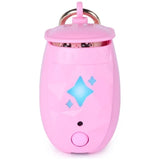 Pink Peekimo interactive digital pet with its lid nearly closed, showing the pet's eyes through the narrow opening and blue illuminated star shapes above the circular button.