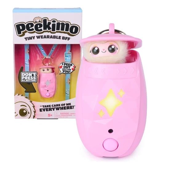 Pink Peekimo Tiny Wearable BFF interactive pet with large eyes and fluffy cream coloured fur peeking out of its pink pod, featuring glowing yellow stars and a round button, displayed beside matching pink retail packaging with a blue patterned lanyard.