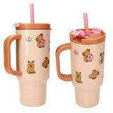 Two angled views of the PENfection CAPYBARA cup showing the handle, straw and printed capybaras