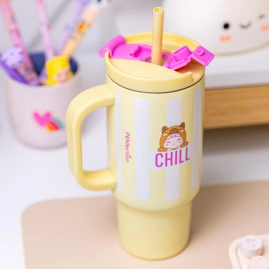Yellow PENfection CHILL cup with straw standing on a desk beside a pen holder