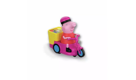 Close-up of Peppa Pig wearing a pink bicycle helmet and red dress, riding a pink three-wheeled bike with blue wheel centres and a yellow basket carrying colourful accessories at the back.