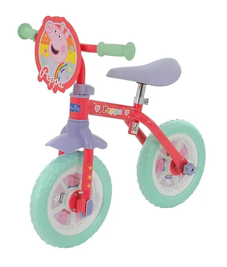 Peppa Pig training bike with mint wheels, purple saddle and front character plaque shown from a left angled view