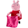 Front view of Peppa Pig soft toy in a red dress holding the pink patterned blanket in front