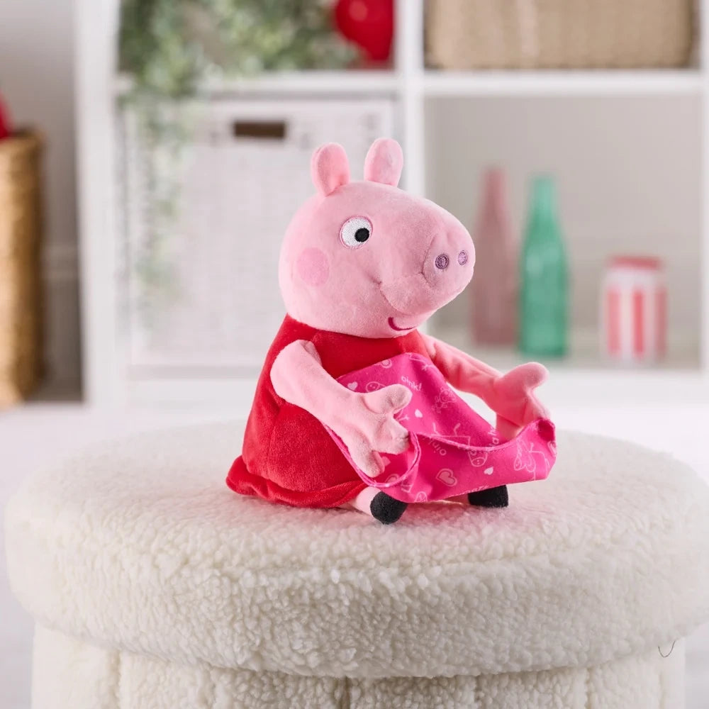 Peppa Pig soft toy seated on a cream stool holding the pink patterned blanket across her lap