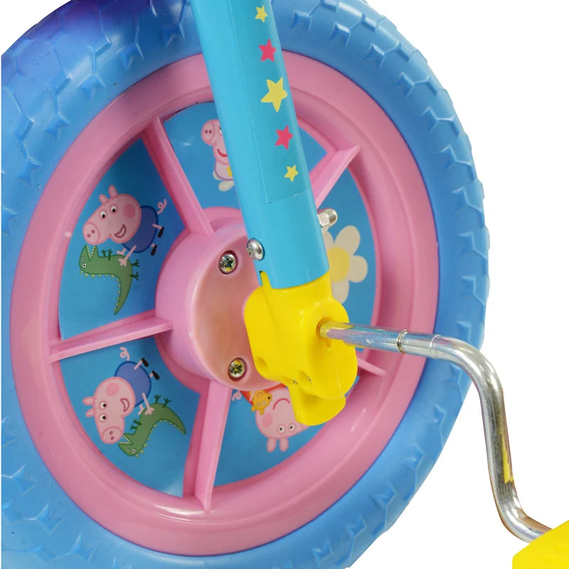 Peppa Pig 10 Inch Training Bike close up of the front wheel, blue tyre, pink wheel and stabiliser fitting