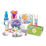 Perfume Creator bottles, bowls, flowers, pipette and tubes containing coloured liquids.