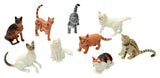 Nine cat figures arranged together in black, orange, white, grey and patterned designs