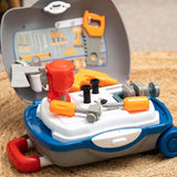 Open Little Workshop Suitcase with red bench drill, grey vice, orange saw, toy drill, hammer, screwdriver and two black bolts