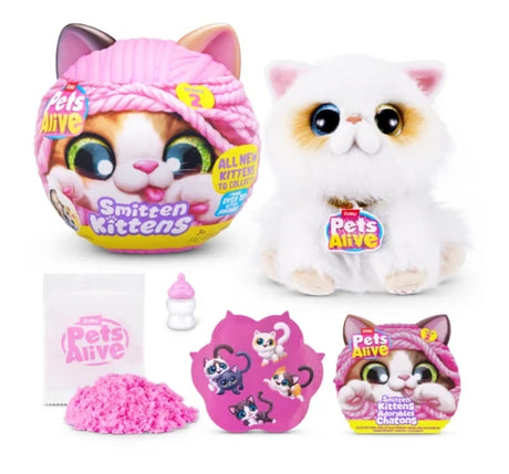 Pets Alive Smitten Kittens Series 2 white Persian style plush kitten with blue and gold eye detail beside pink capsule, pink kinetic sand, milk bottle, sticker sheet and leaflet on white background
