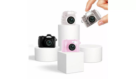 White, silver, black and pink Photo Creator Mini Cam cameras displayed on white blocks