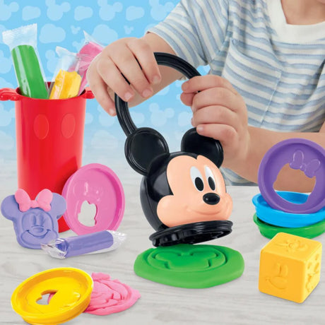 Child using the Play-Doh Disney Junior Happy Stackable set with Mickey stamper, shape discs and red stacking container