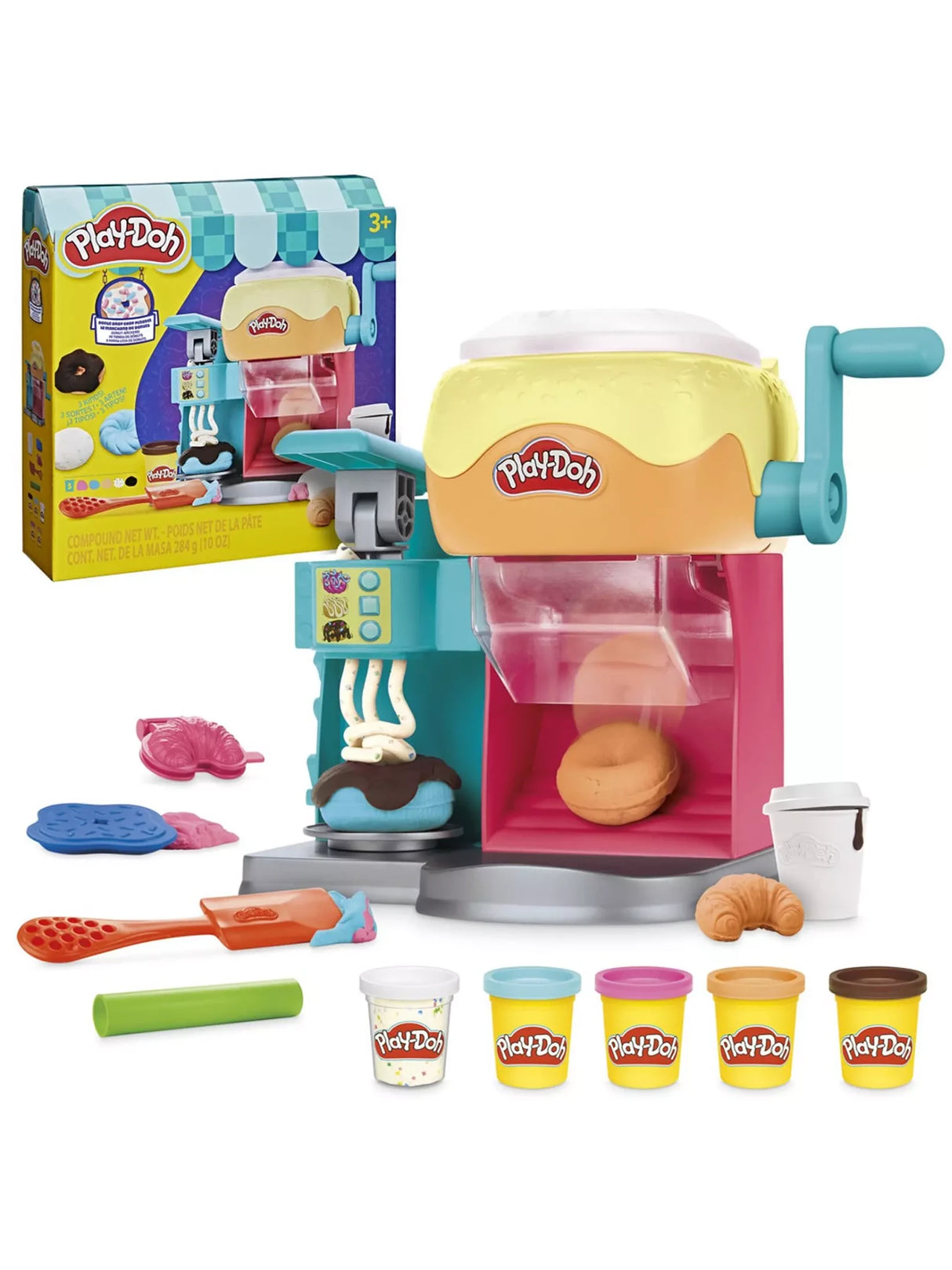 Play-Doh Donut Drop Shop Playset with doughnut machine, spatula, moulds, pretend coffee cup and five Play-Doh tubs with packaging in the background