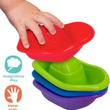 Child's hand placing a red Play Tots bath boat on top of green, blue and purple stacked boats