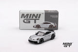 Mini GT Porsche 911 Dakar Ice Grey Metallic model displayed in front of its grey Mini GT box with the car pictured on the packaging