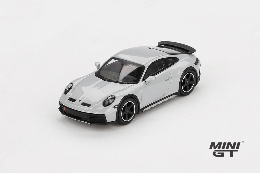 Mini GT Porsche 911 Dakar Ice Grey Metallic LHD prototype viewed from the front left showing the raised stance, black bonnet vents and black wheels