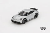 Mini GT Porsche 911 Dakar Ice Grey Metallic LHD prototype viewed from the front left showing the raised stance, black bonnet vents and black wheels